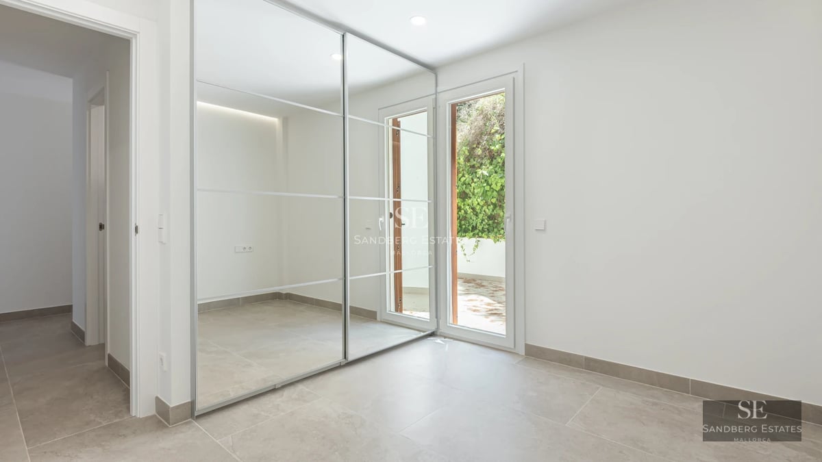 Spacious terrace with sea view, modern furniture, wooden floors, glass railing. Contemporary design.