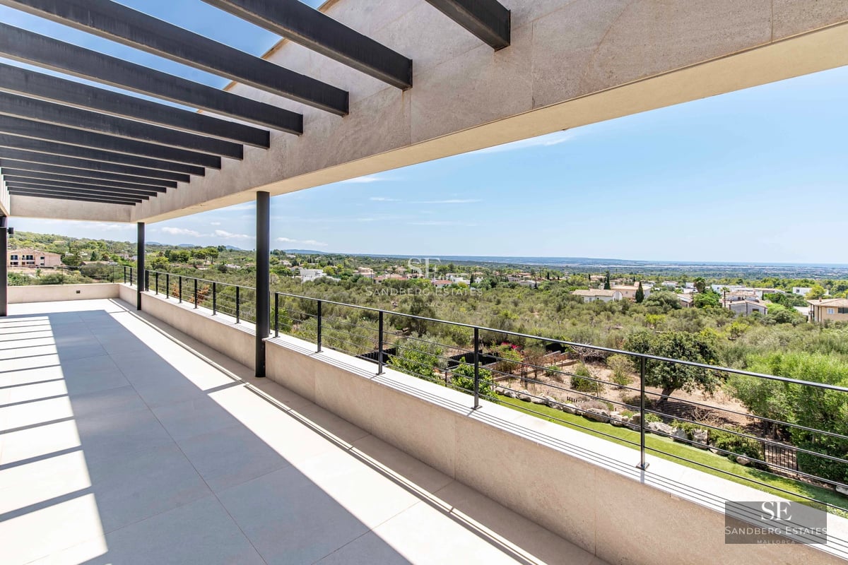 Spacious terrace with infinity pool, sun loungers, and ocean view. Sleek, modern design with high-end finishes.