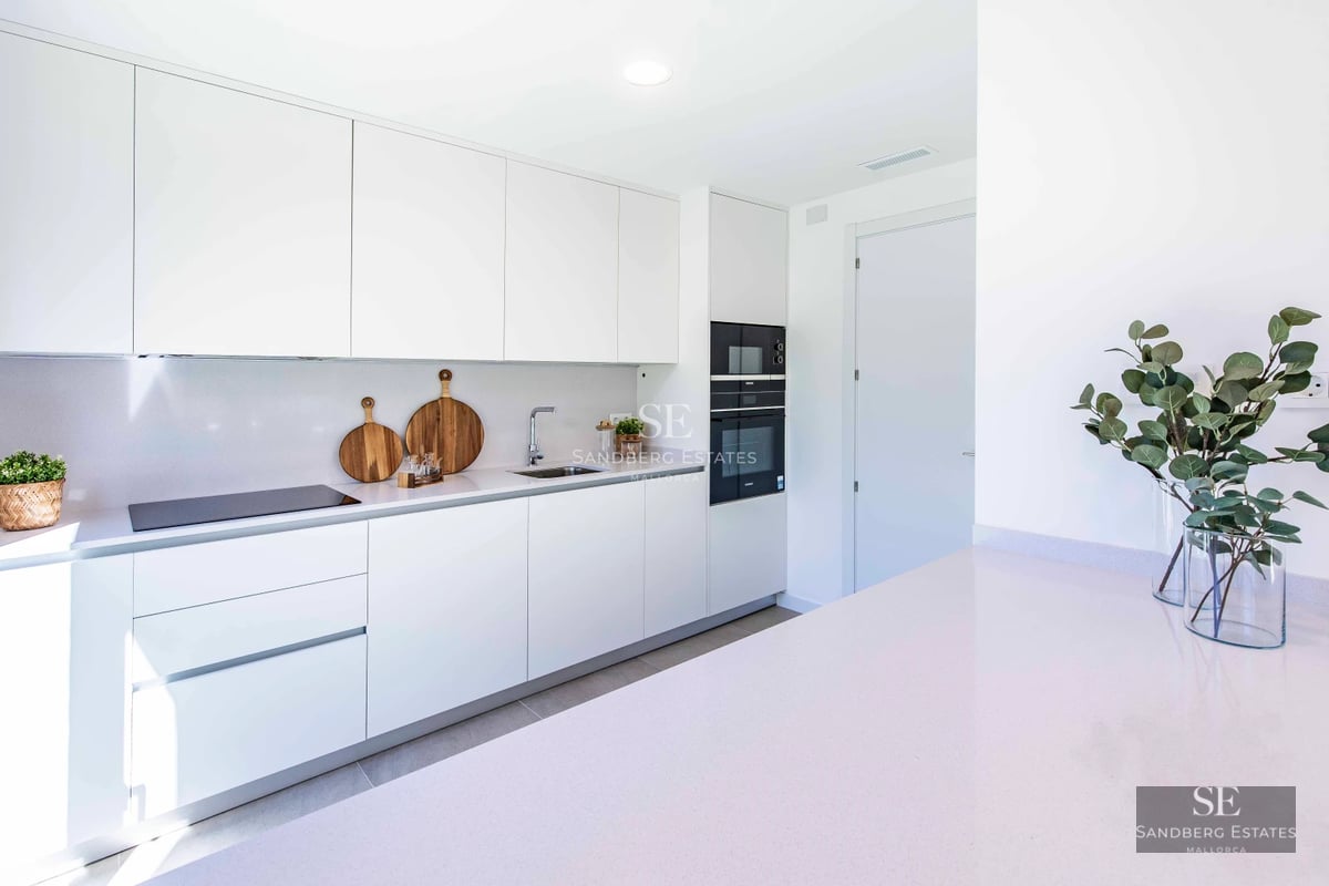 Minimalist facade with expansive windows. Infinity pool reflects the blue sky. Lush garden. Sleek, modern design.