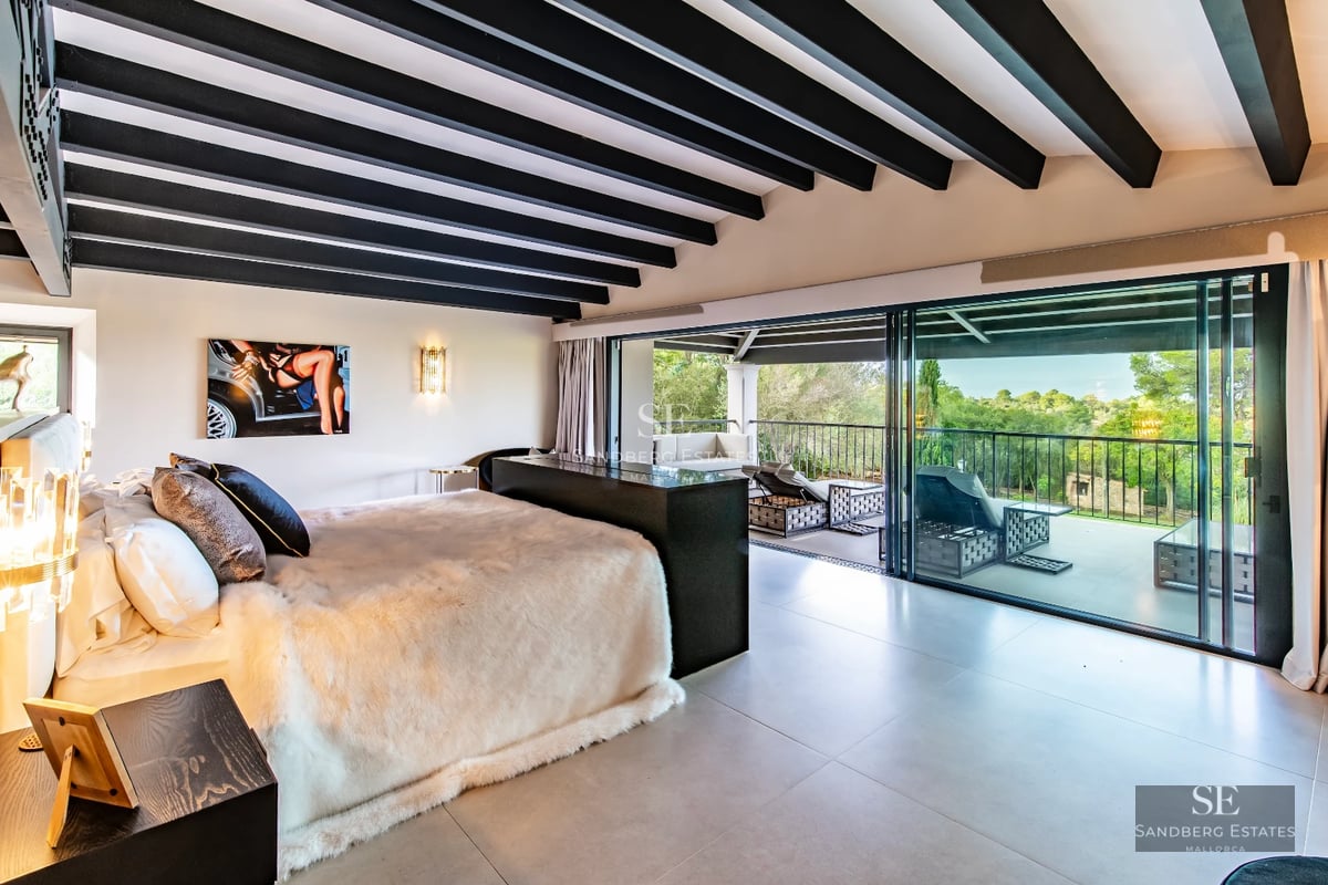 Spacious, bright living room with large windows, modern fireplace, light wood floors, and minimalist decor. Open space with garden views.