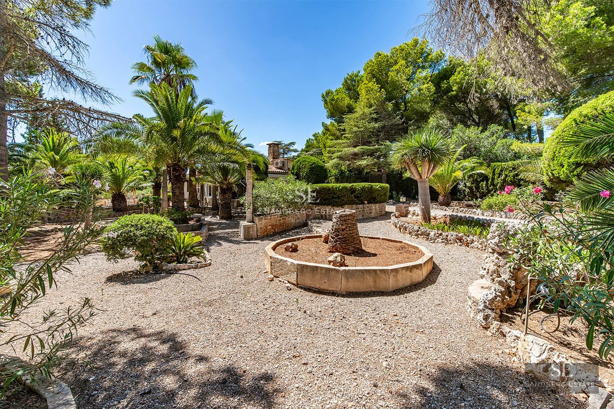 Exterior view of a modern villa featuring an infinity pool, expansive terraces, minimalist design with large windows, and lush landscaping.