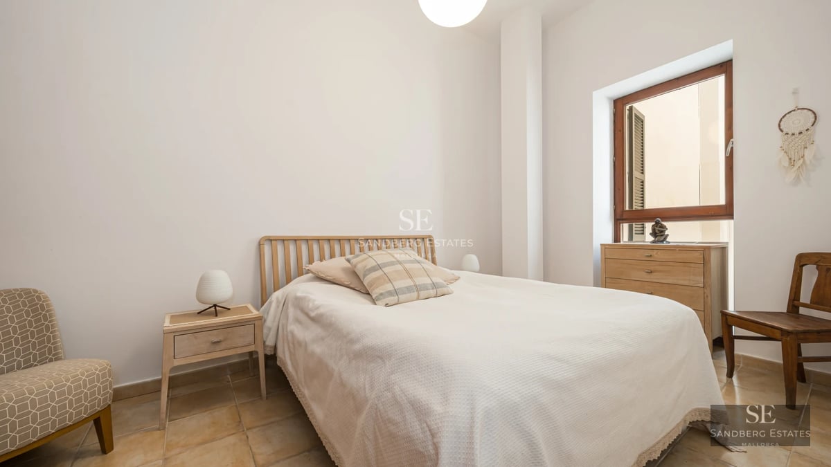 Exterior view of a modern house featuring a reflective pool, lush garden, and spacious patio. Sleek and contemporary architectural design.