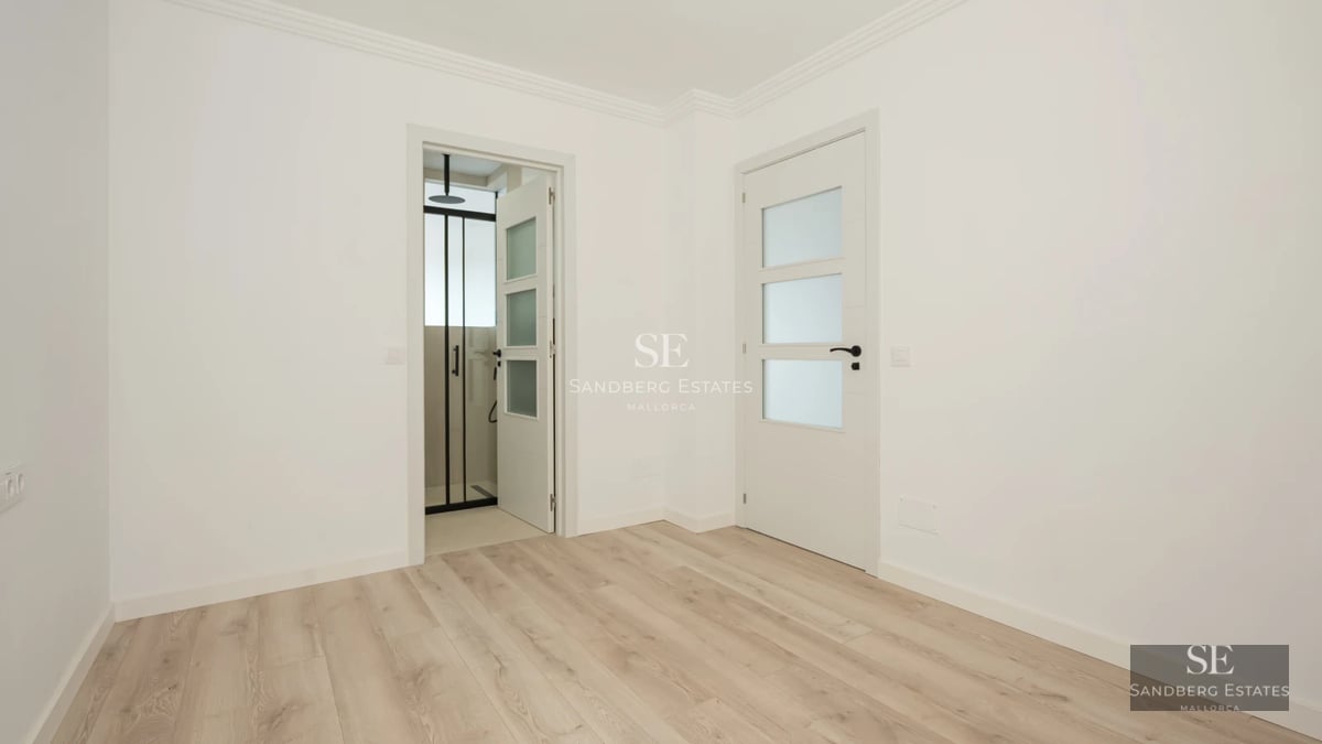 Exterior view of a modern villa featuring a pool, garden, and minimalist architectural design. Large windows reflecting natural light.