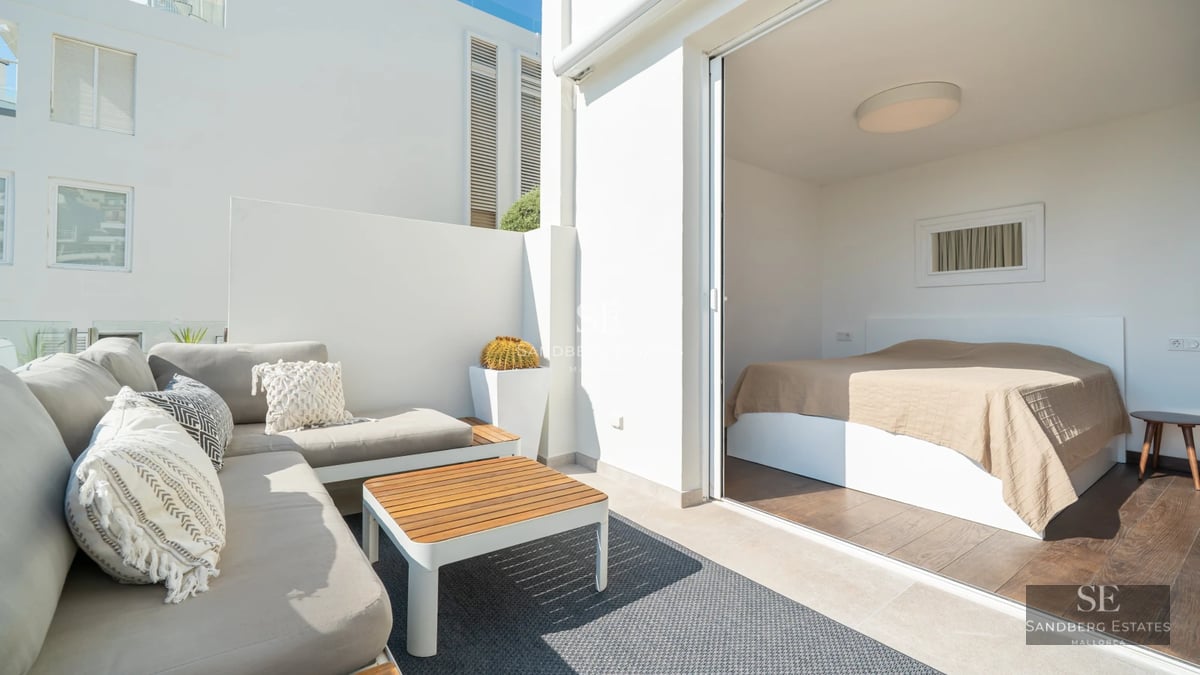 View of infinity pool with terrace and lush greenery. Modern architecture with large windows. Elegant exterior design.