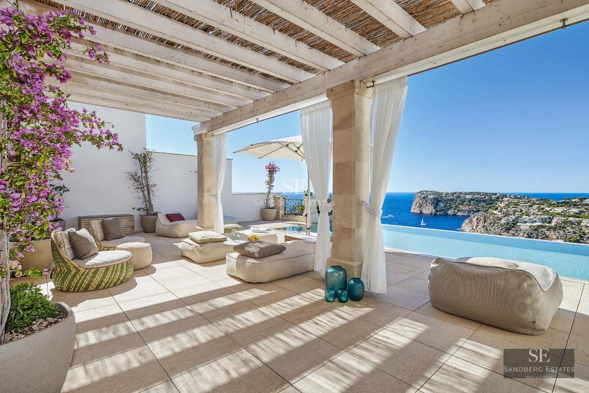 Exterior view of a modern villa with an infinity pool, lush garden, and spacious terraces. Elegant architecture and landscaping.