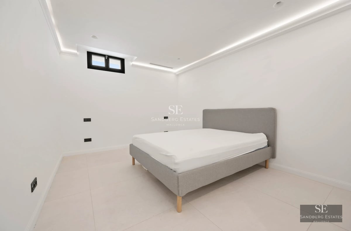 Exterior view of modern villa featuring an infinity pool, large windows, minimalist architecture, and lush garden.