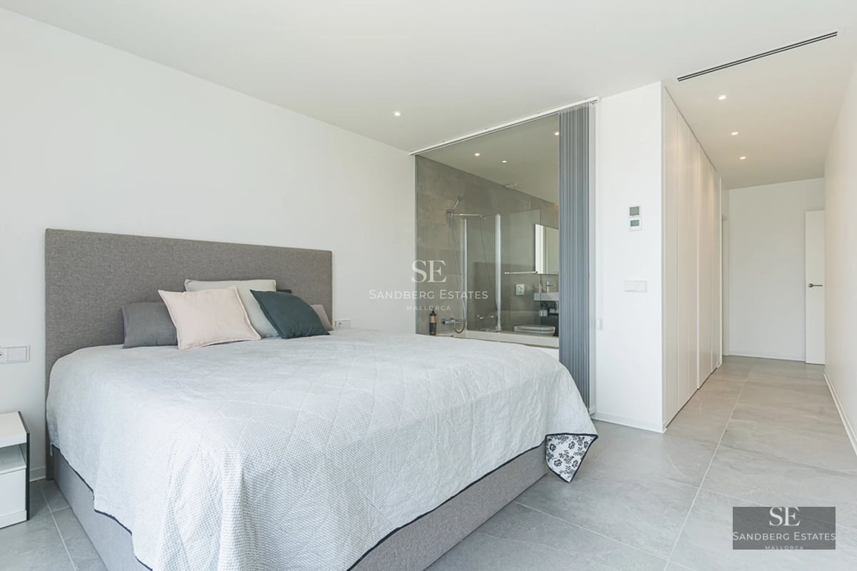 Spacious balcony with panoramic sea views. Modern and elegant furniture. Warm ambient lighting.