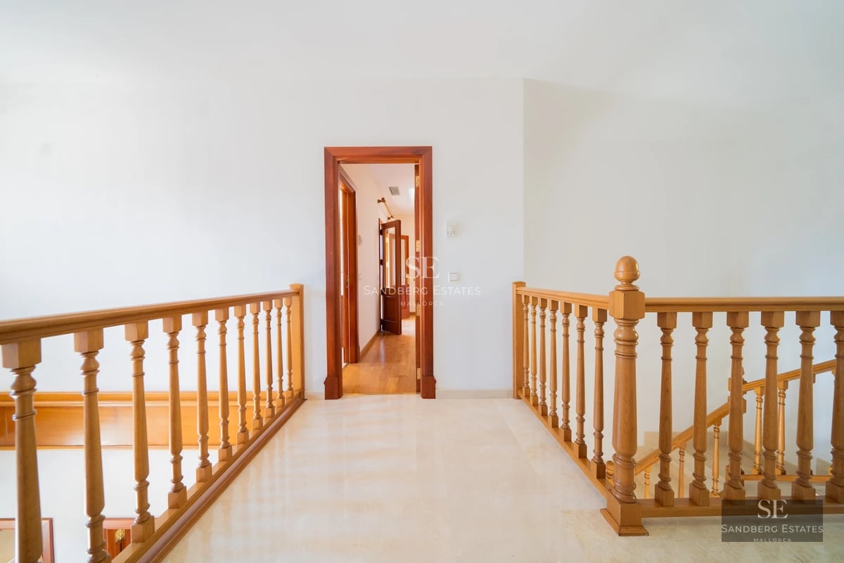 Exterior view of a modern villa with an infinity pool, expansive terraces, and minimalist design. Lush garden and abundant natural light.