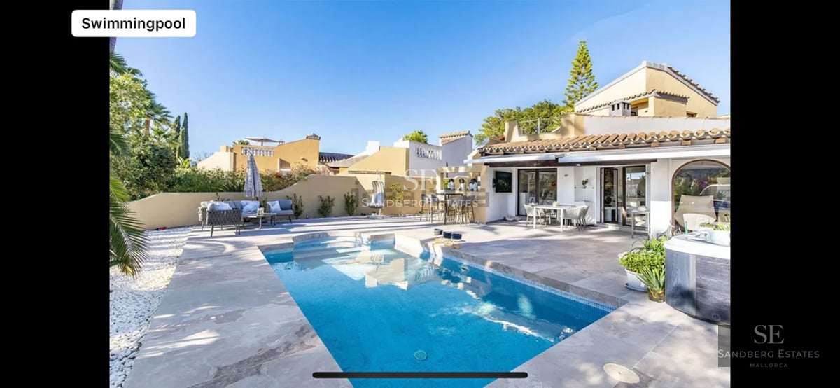 Spacious terrace with infinity pool, panoramic views, modern furniture, and lush vegetation. Contemporary architectural design.