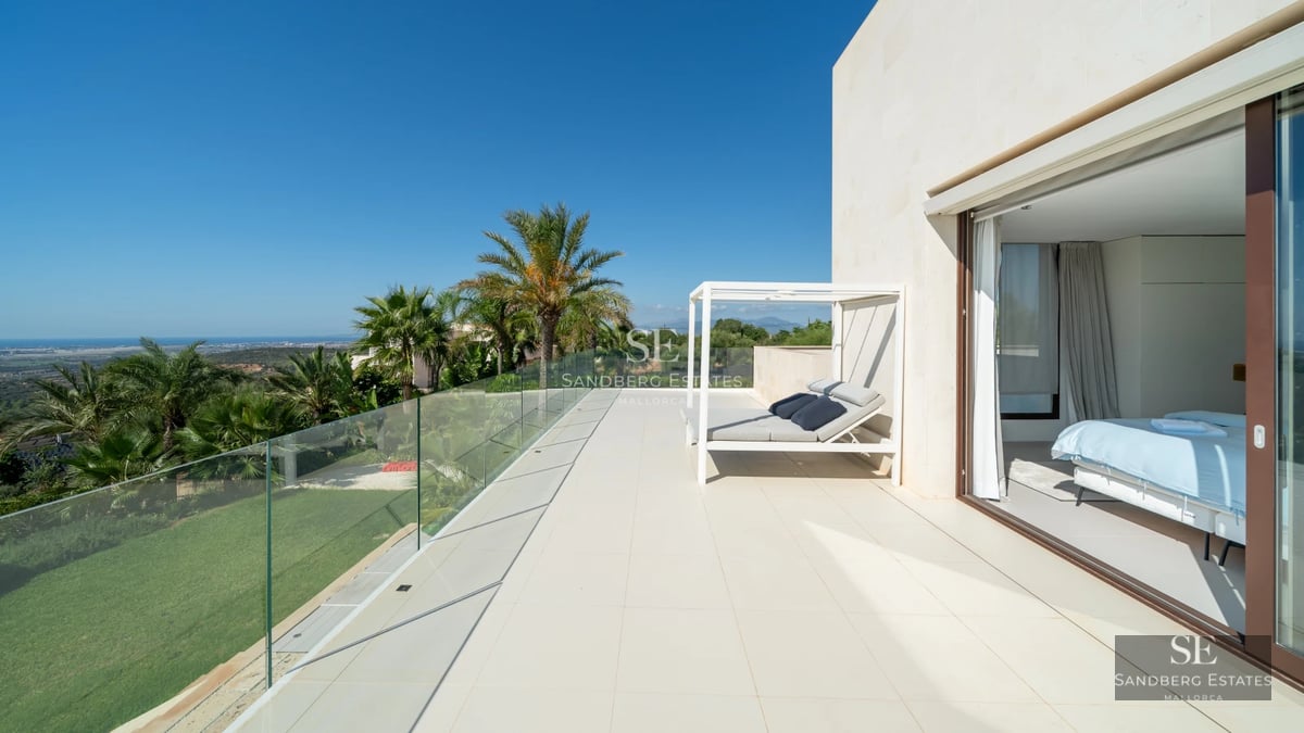 Exterior view of a modern villa featuring a pool, large glass windows, and lush garden. Minimalist design and high-quality finishes.