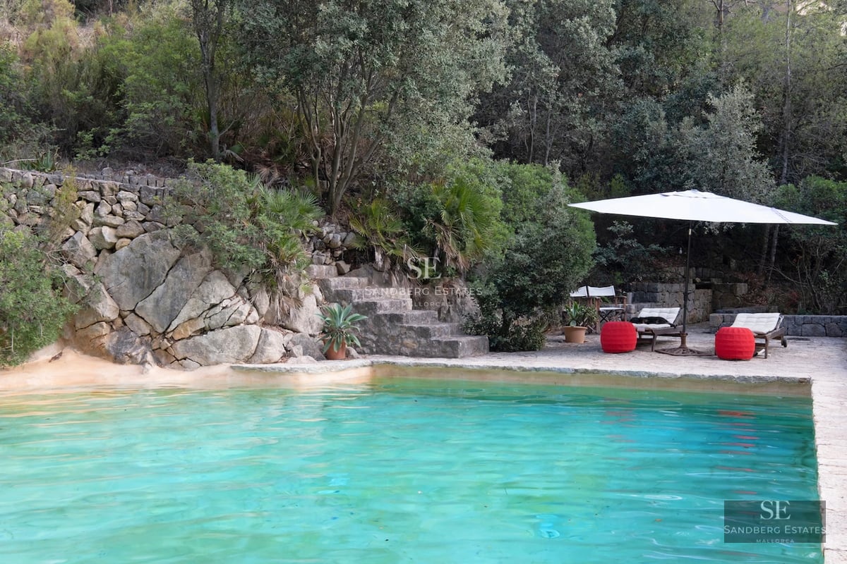 Spacious living room with large windows and a sea view. Modern furniture, neutral color palette, and abundant natural light.