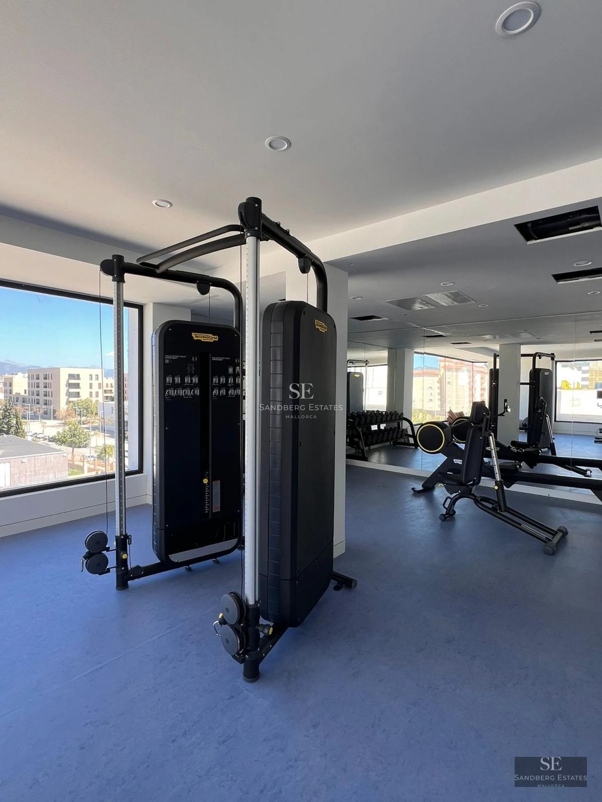 Spacious living room with large windows offering stunning sea views. Modern design, natural lighting, and hardwood floors.