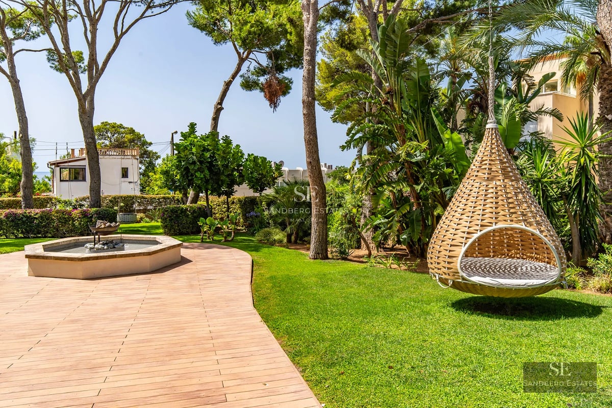 View of modern villa with infinity pool. Minimalist architecture, large windows, and lush garden. Contemporary design.