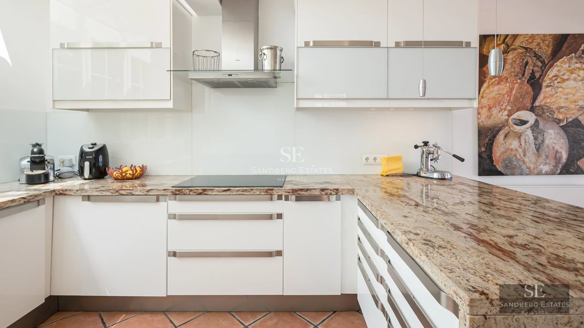 Spacious terrace featuring an infinity pool and panoramic sea views. Modern, elegant furniture. Lush greenery.