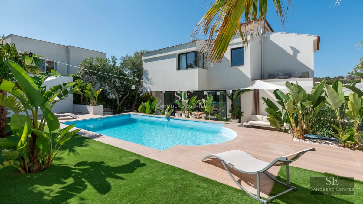 Exterior view of a modern villa with a pool. Sleek design, large windows, and landscaped surroundings. Ideal for investment.