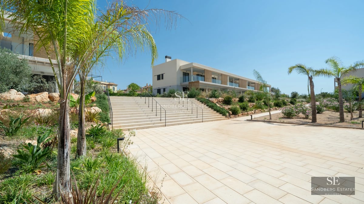 Exterior view of a modern villa with a pool, large windows, and sleek design. Minimalist architecture and lush gardens.