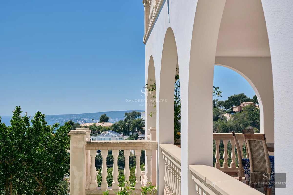 Exterior view of a modern villa featuring an infinity pool, garden, and large terraces. Minimalist design with expansive windows.