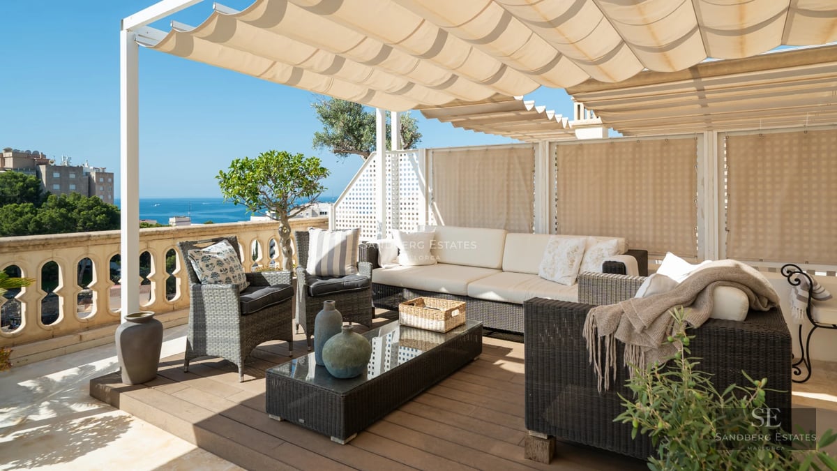 Exterior view of a modern villa featuring a pool, lush garden, and expansive windows. Contemporary architectural design.