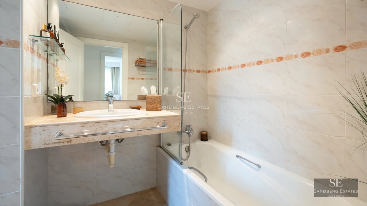 Modern terrace overlooking the sea. Elegant furniture, glass railing, ambient lighting. Contemporary design.