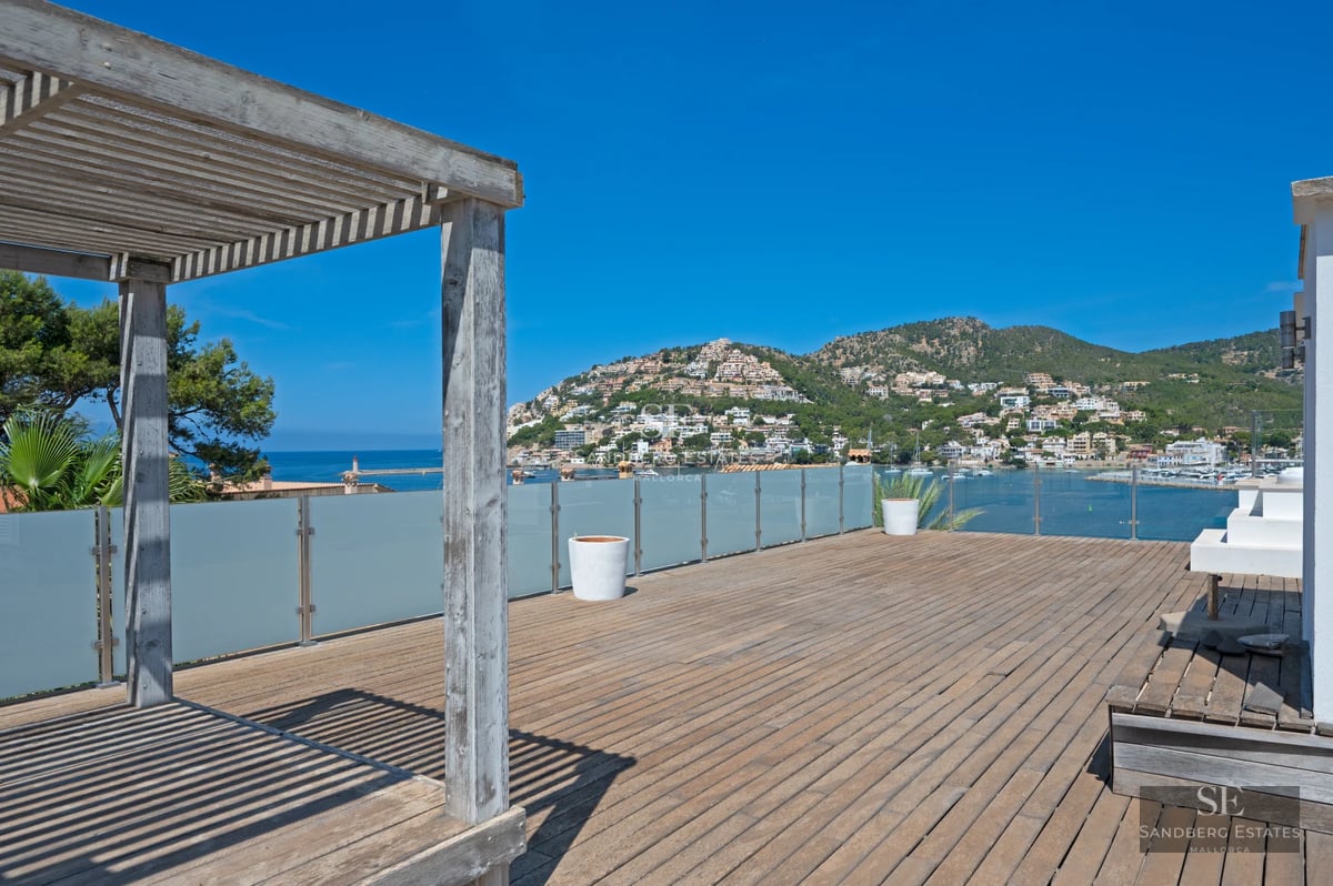 Exterior view of a modern home with a pool. Minimalist architecture, large windows, and lush natural surroundings.