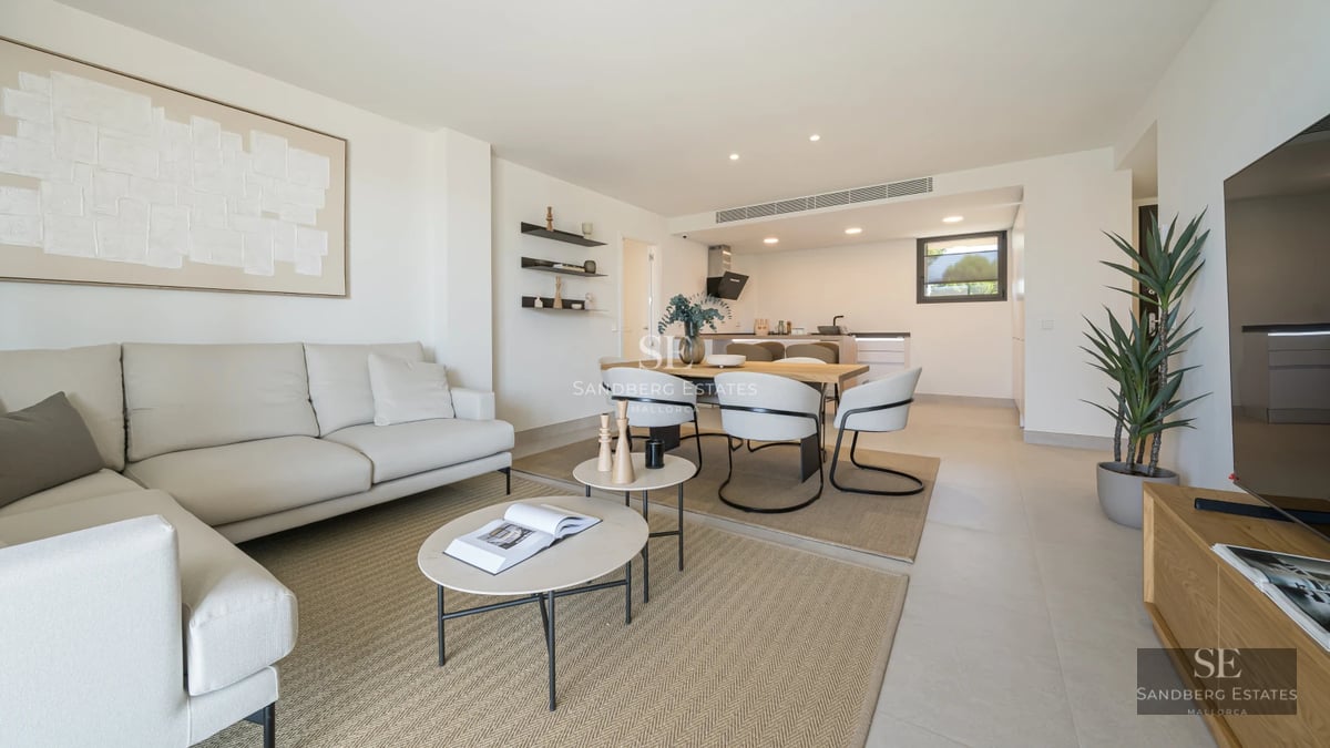 Bright living room with large windows, light wood floors and modern furniture. Panoramic views and minimalist decoration.