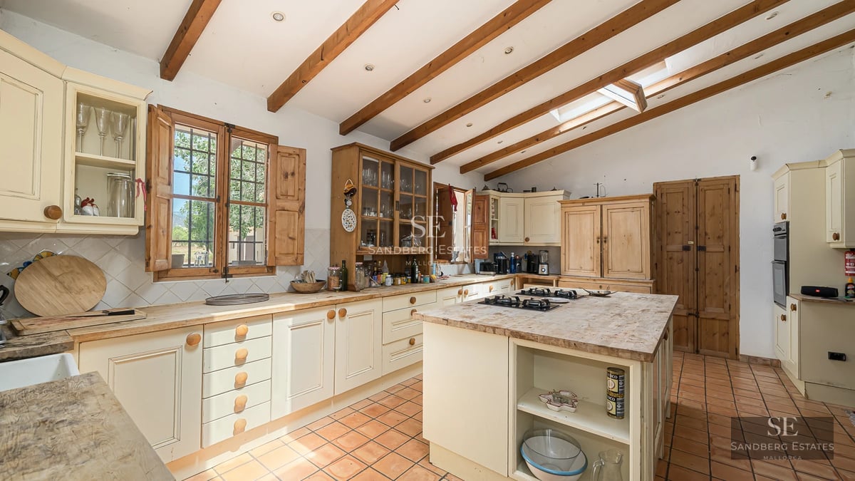 Exterior view of a modern villa featuring a reflective pool, large windows, and lush landscaping.