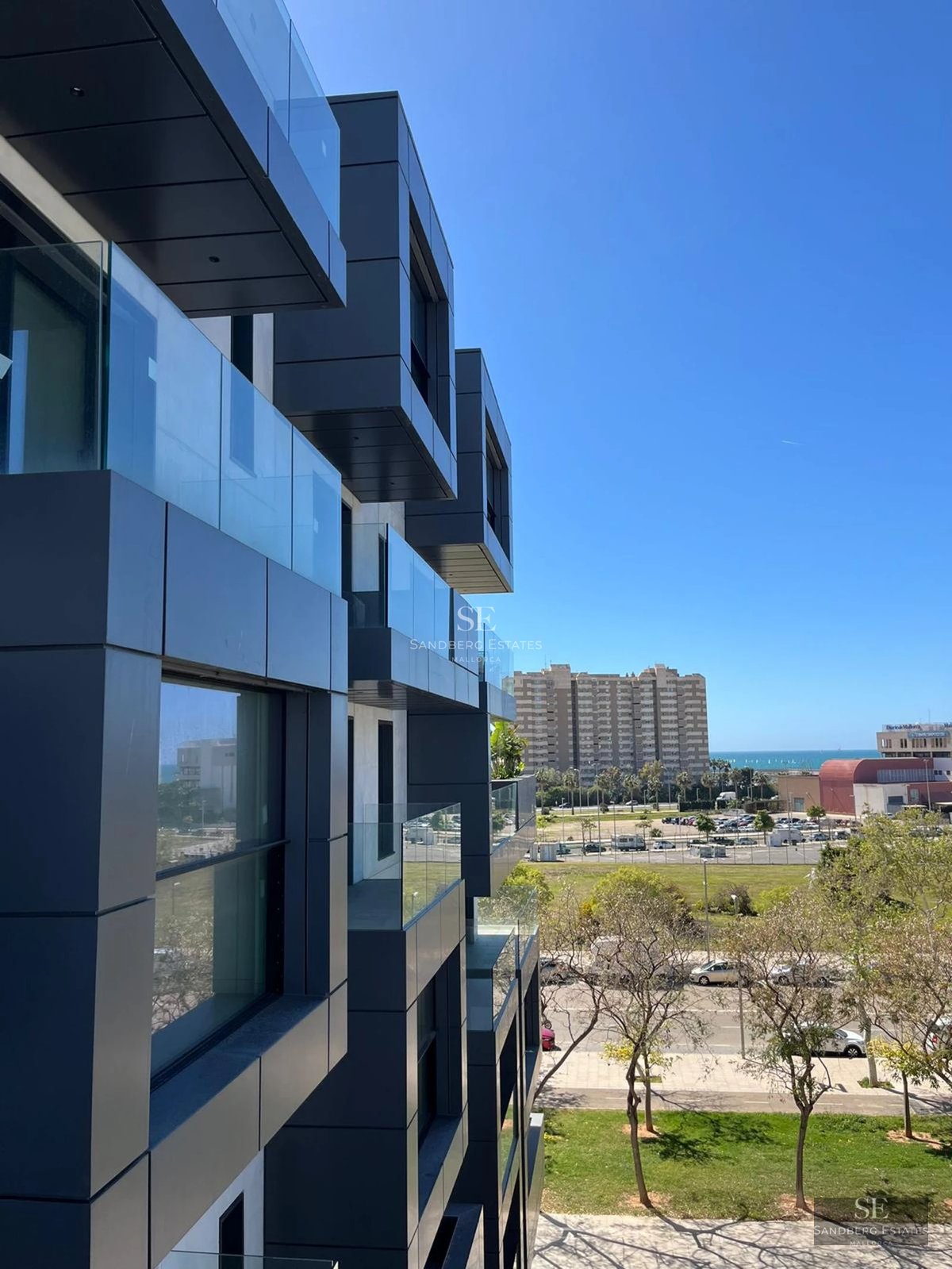 Exterior view of a modern villa featuring an infinity pool, lush garden, and minimalist architecture. Large windows and elegant design.