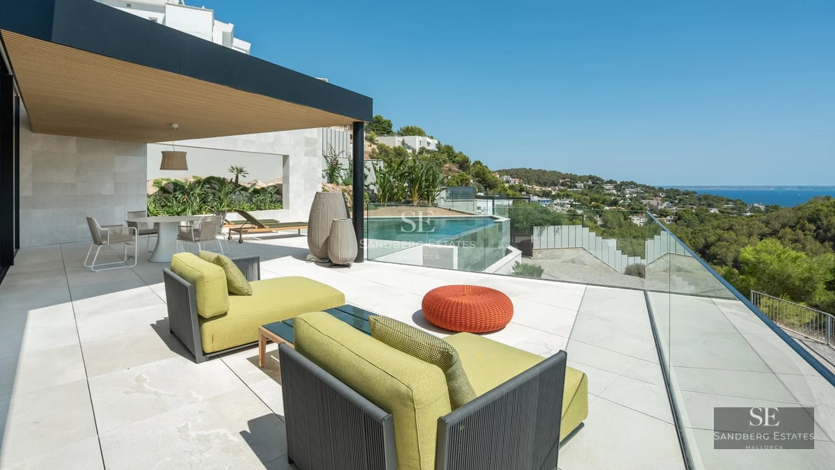 Expansive terrace featuring an infinity pool, modern sun loungers, and panoramic views. Minimalist architecture and contemporary design.