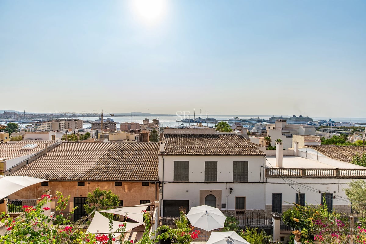 Spacious living room with floor-to-ceiling windows overlooking infinity pool. Modern sofas, elegant coffee table. Natural light, minimalist design.