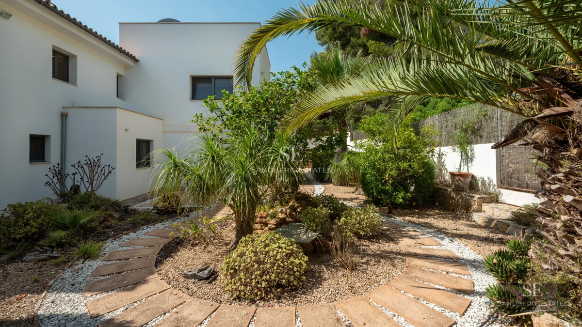 View of modern villa with infinity pool. Minimalist design, large terraces, and panoramic views. Warm lighting and serene environment.