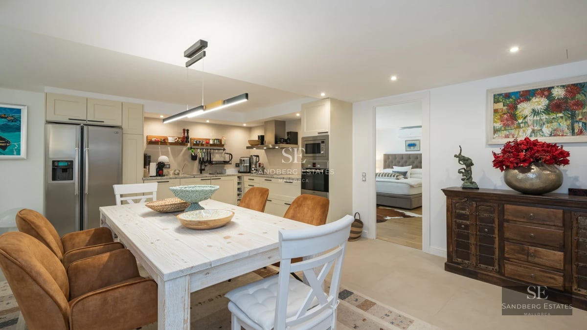 Exterior view of a modern villa with infinity pool, sun loungers, and lush greenery. Minimalist architecture with large windows.