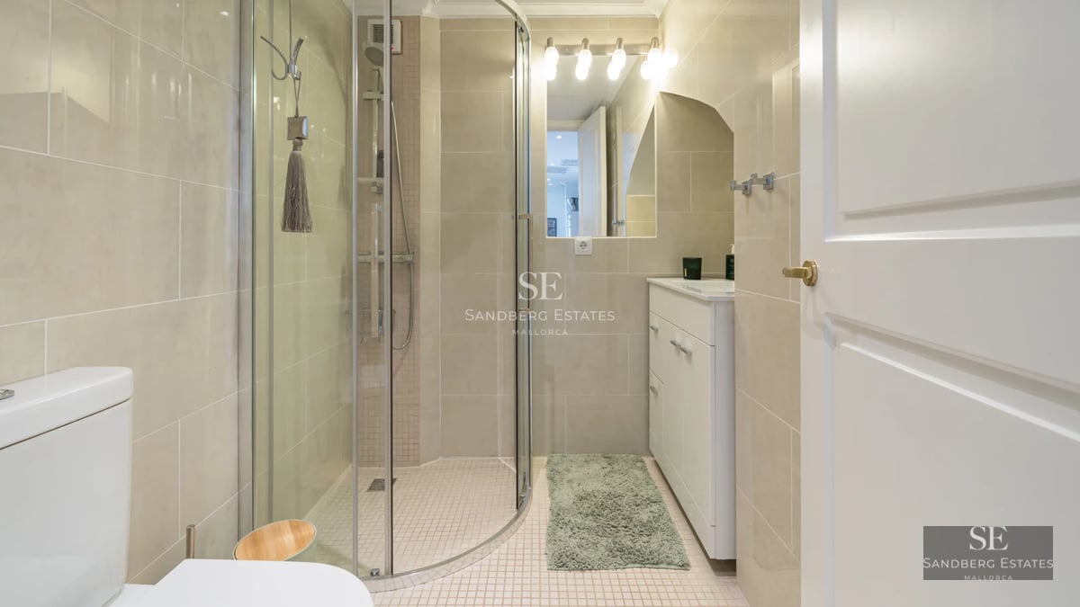 Wide terrace with infinity pool, sea view. Glass railing, sun loungers, and modern minimalist architecture.