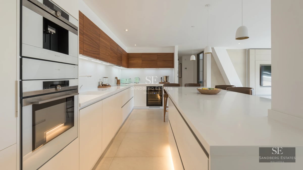 Exterior of a modern villa featuring an infinity pool, lush gardens, and spacious terraces. Minimalist design with panoramic windows.