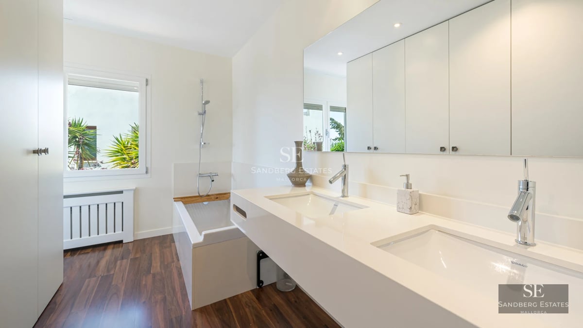 Aerial view of modern villa with pool, lush garden and minimalist architecture. Expansive terraces and abundant natural light.