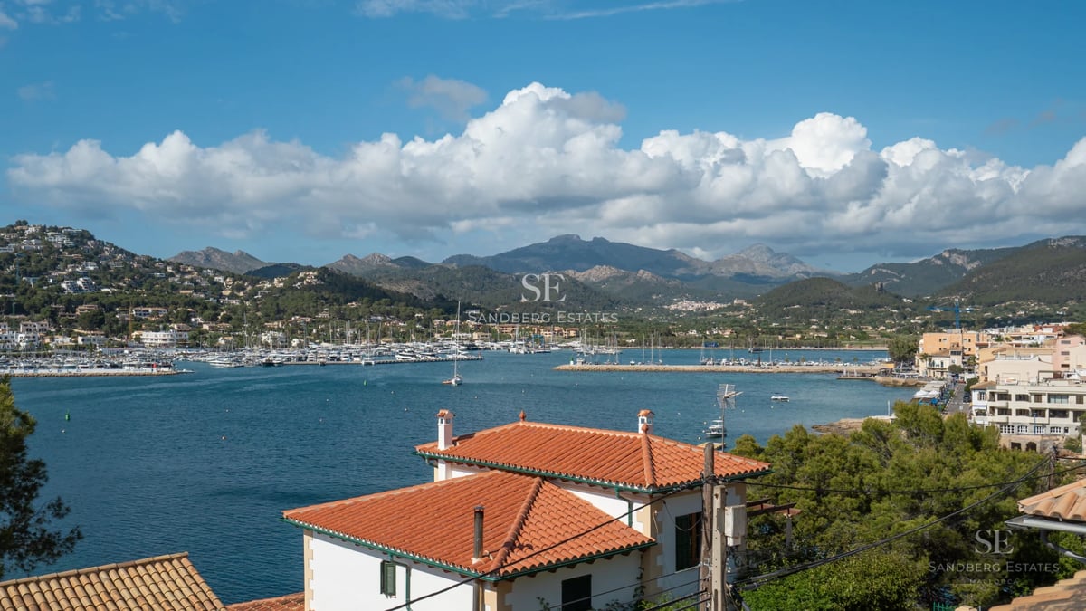 Modern villa exterior with reflecting pool, expansive windows, and manicured landscaping. Soft lighting highlights the architecture.