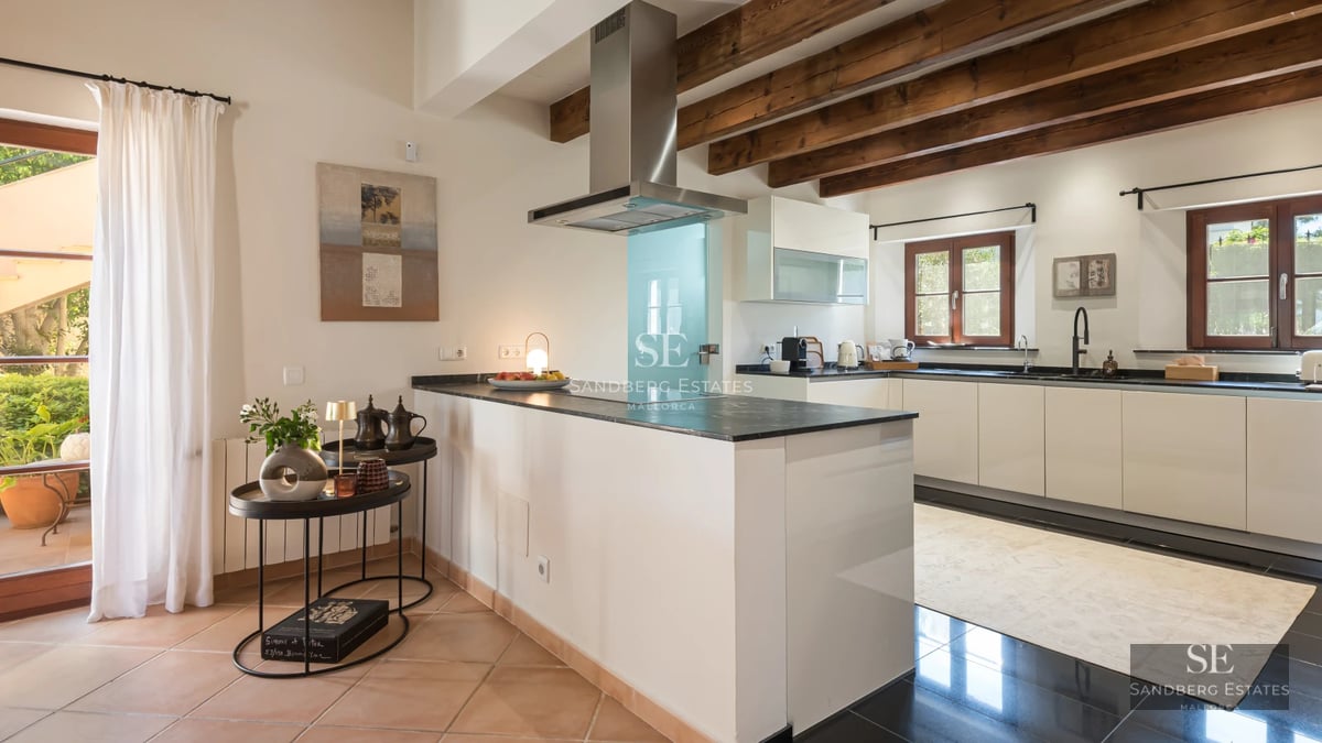 Bright living room with large windows, light wood floors, and panoramic sea views. Minimalist and modern decor.