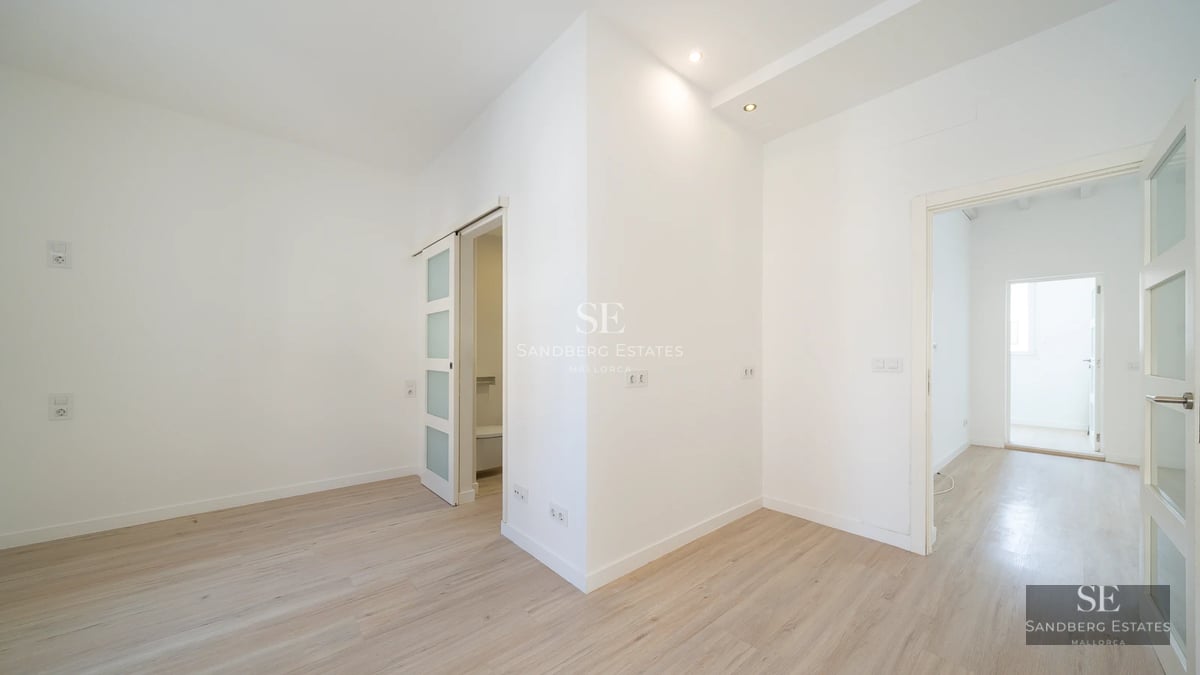 Spacious terrace featuring an infinity pool with ocean views. Modern furniture, glass railings, and lush vegetation.