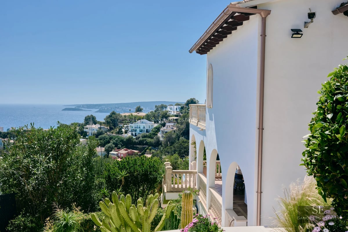 Garden view featuring a pool, modern furniture, and lush landscaping. Architectural details highlight the property's elegance.