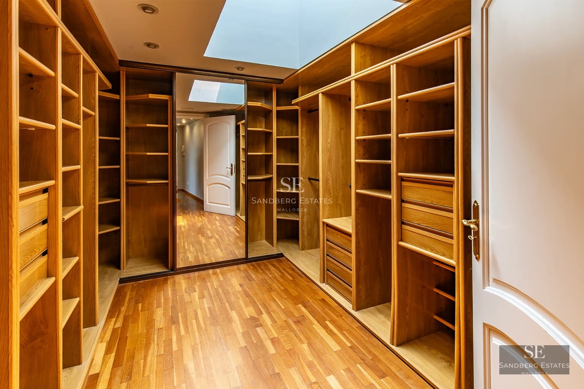 Spacious balcony with panoramic sea views. Modern furniture, glass railing, and tiled floor. Luxury and comfort.