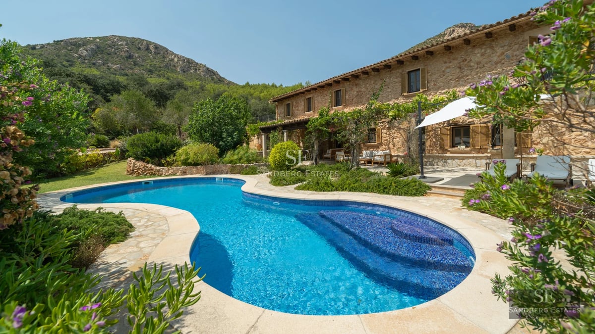 Spacious living room with sea view windows, modern and elegant decor, light wood floors, and designer furniture.
