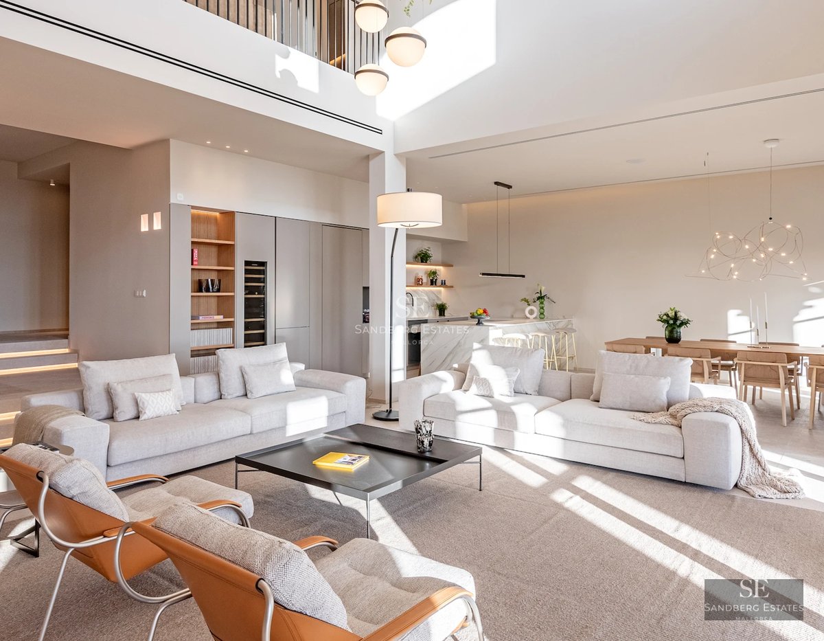 Expansive terrace with infinity pool. Modern design featuring wood flooring and ocean views. Loungers and umbrellas for relaxation.