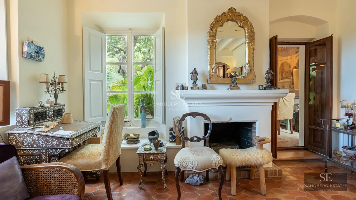 Exterior view of a modern villa featuring a pool, manicured lawn, and large windows reflecting sunlight.