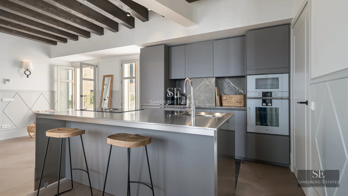 View of a luxurious pool with terrace, loungers, lush greenery, and modern architecture. Natural lighting and relaxing atmosphere.
