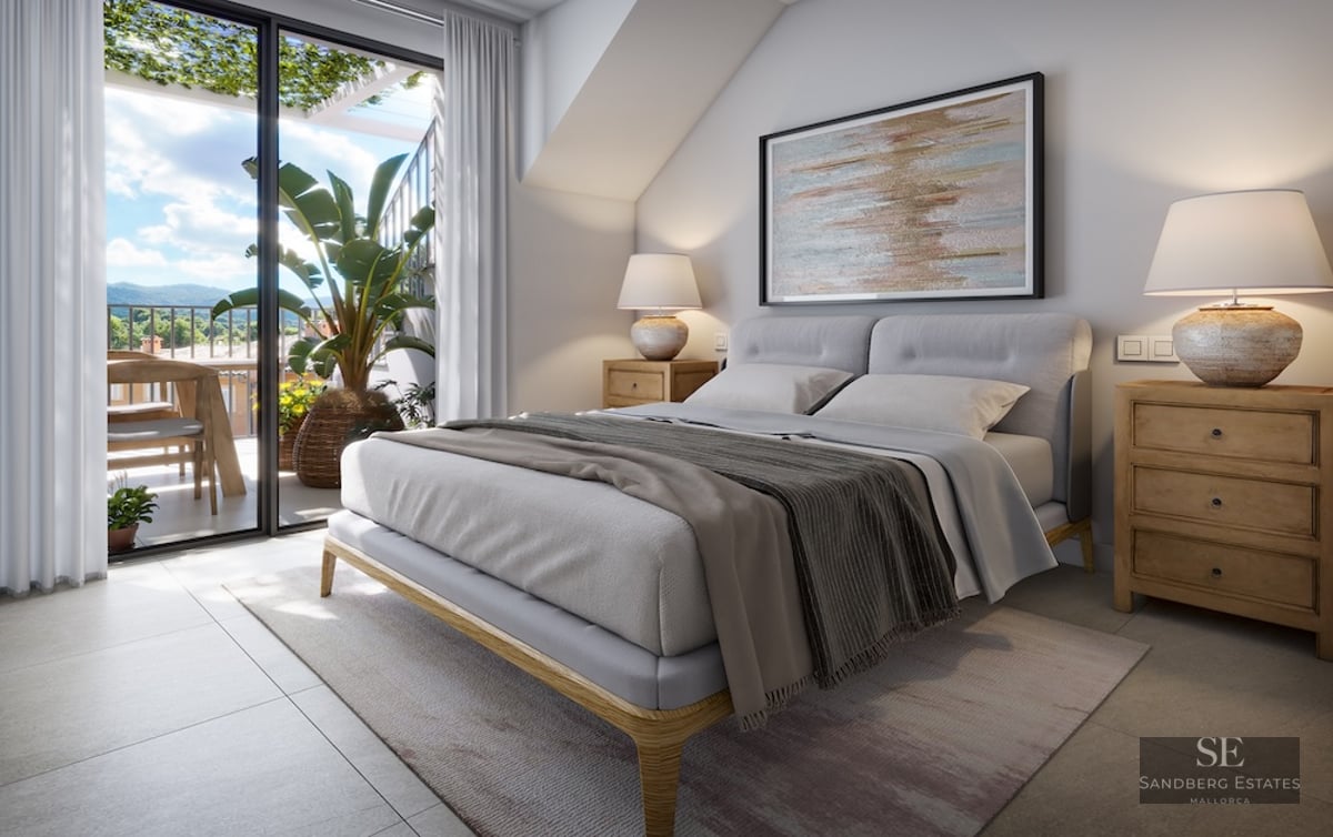 Modern master bedroom with a large bed, wooden nightstands, and glass doors opening to a sunlit terrace with mountain views.