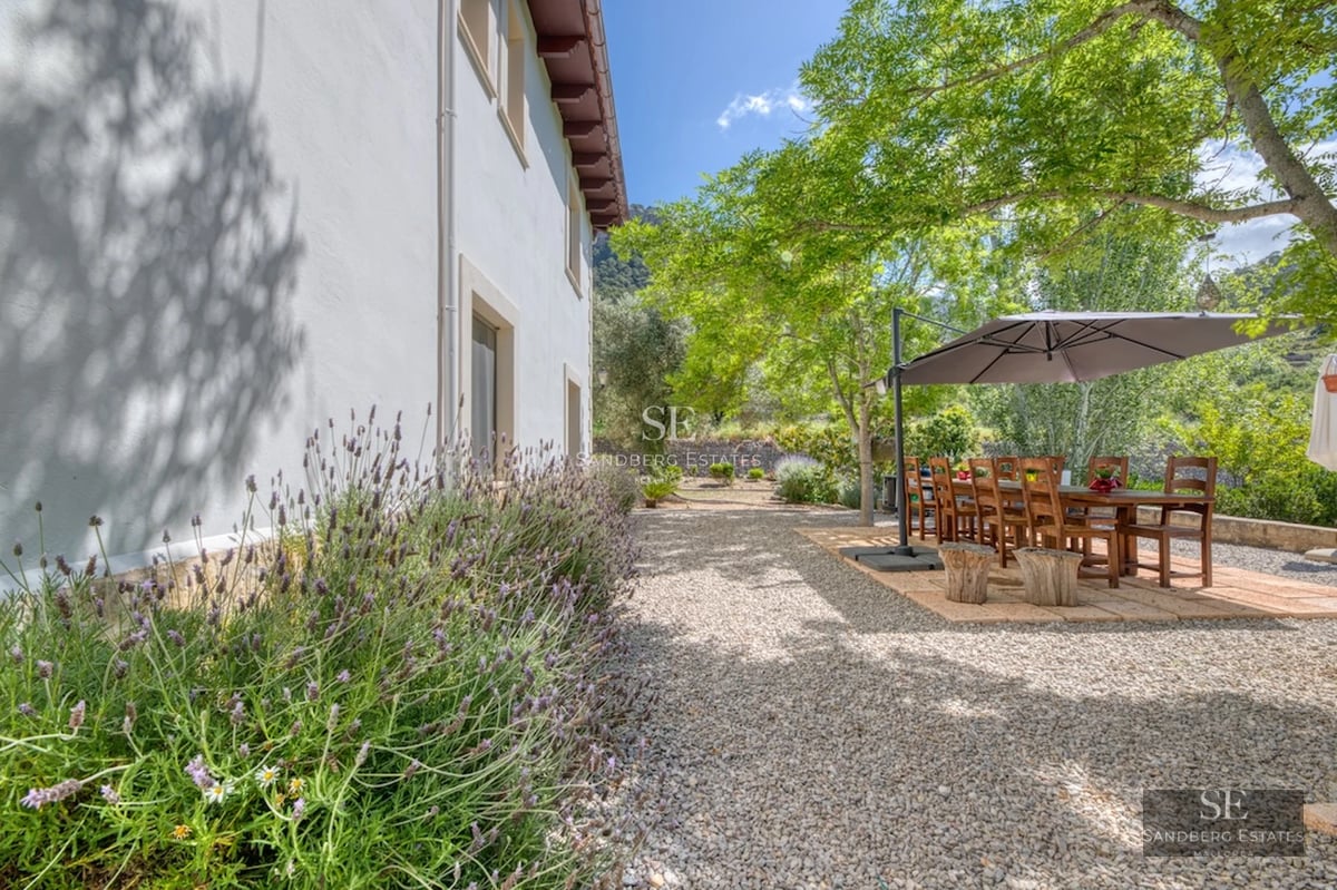 Spacious living room with balcony and sea view. Modern design with natural light, wood flooring, and stylish furniture.
