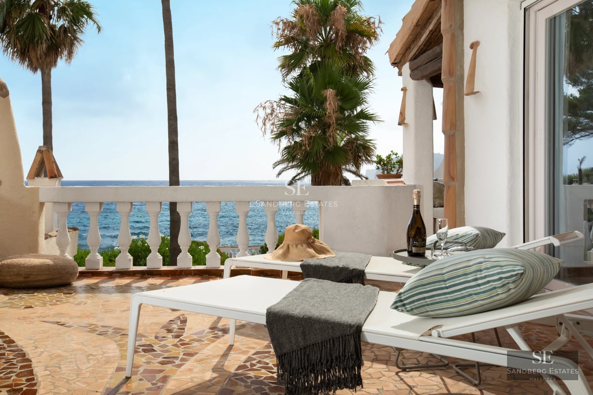 Pool and garden view of modern house with large glass windows. Minimalist design, lush vegetation, warm ambient lighting.