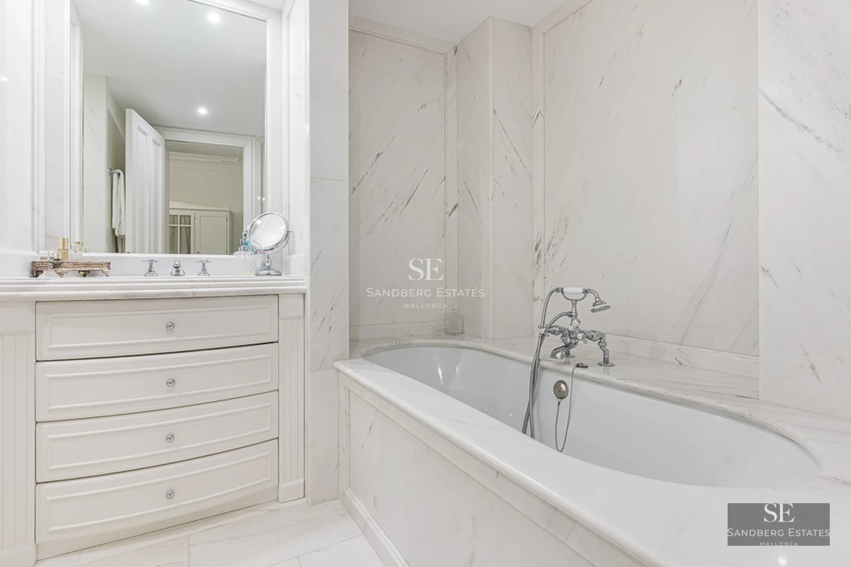 Aerial view of a modern house with an infinity pool, surrounded by greenery and stunning sea views. Minimalist architectural design.