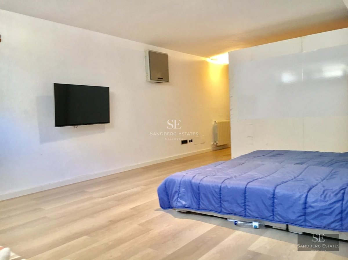 Panoramic view of a modern property featuring an infinity pool and lush gardens. Minimalist architecture with large window fronts.