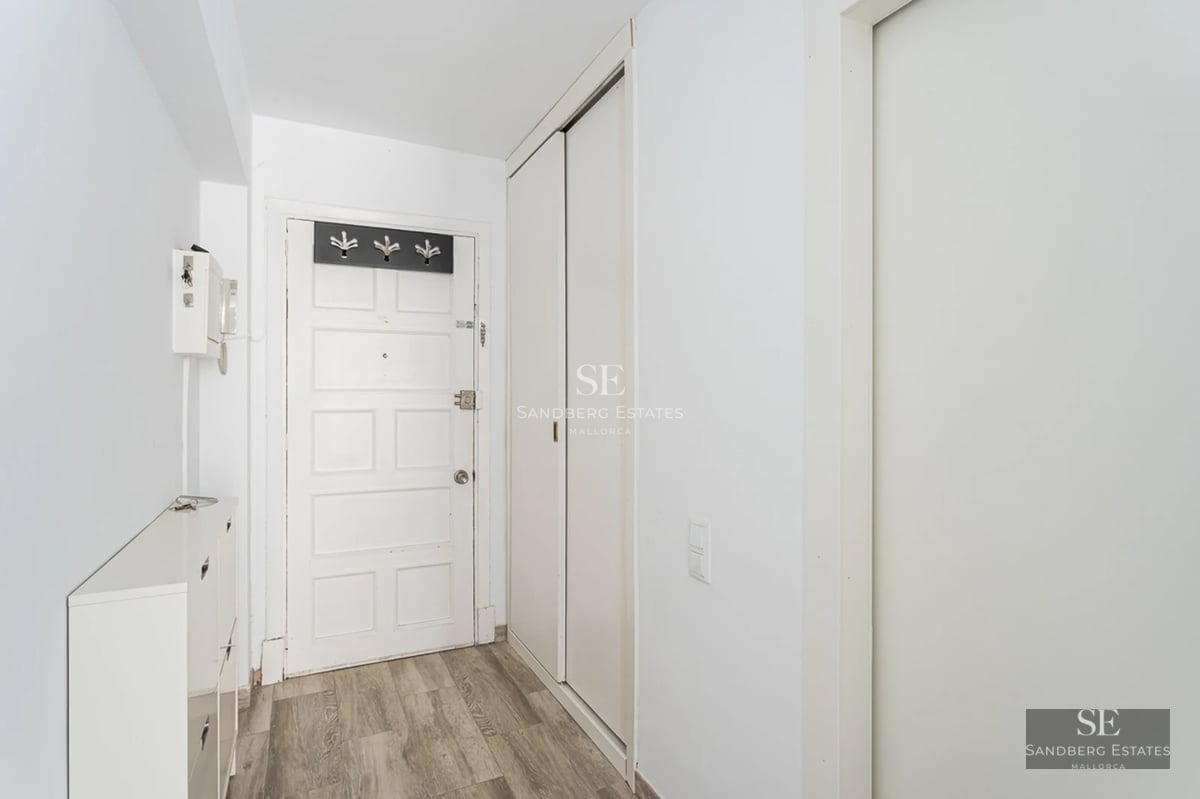 Spacious terrace featuring an infinity pool and panoramic sea views. Modern furniture, wooden floors, and glass railing.