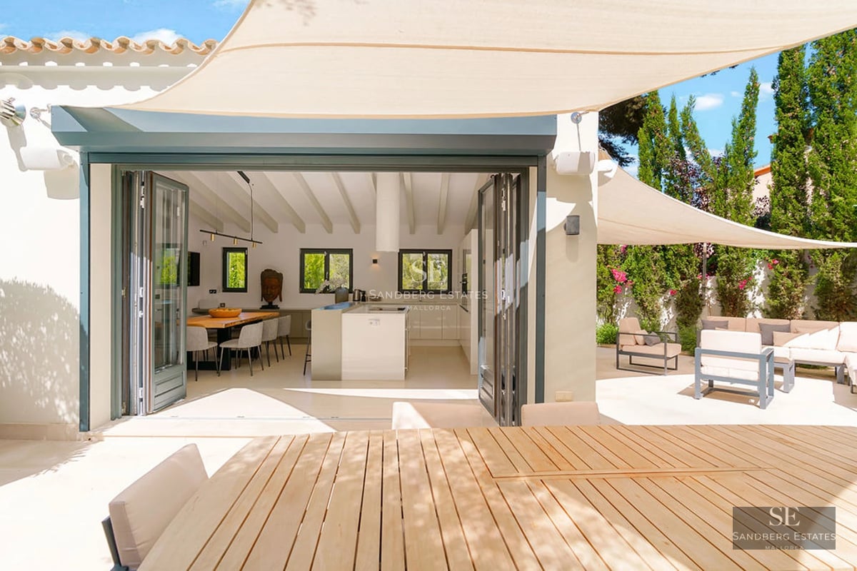 Modern terrace featuring an infinity pool, lounge chairs, ocean views, and stylish furniture. Minimalist design with greenery.